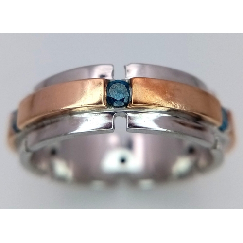 130 - An 18K White and Rose Gold Gents Band Ring - With an eternal setting of six blue topaz stones. Size ... 