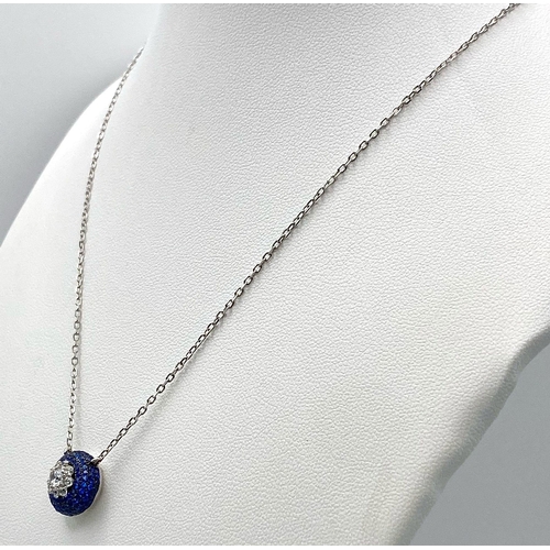 1443 - A Silver and Blue Stone Pendant on a Silver Necklace.