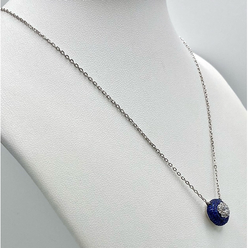 1443 - A Silver and Blue Stone Pendant on a Silver Necklace.