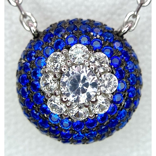 1443 - A Silver and Blue Stone Pendant on a Silver Necklace.