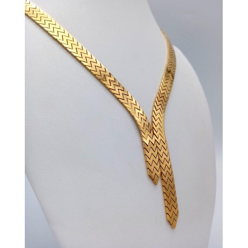 16 - An Elegant 18K Gold Flat Scale Link Necklace with Twin Tassel Extenders. 48cm length. 35.25g weight.