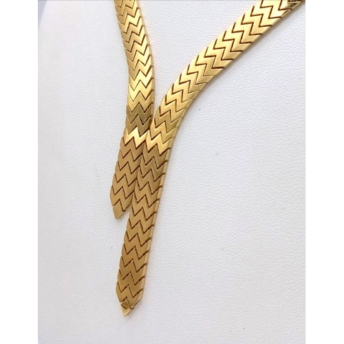 16 - An Elegant 18K Gold Flat Scale Link Necklace with Twin Tassel Extenders. 48cm length. 35.25g weight.