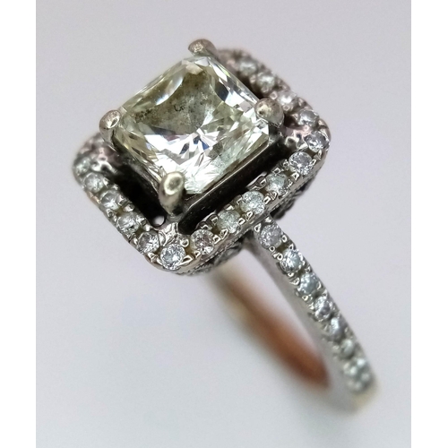 186 - A 14K White Gold Princess Cut Diamond Ring. A beautiful (slightly tinted) 1.13ct central princess cu... 