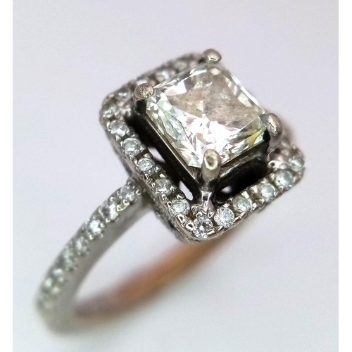 186 - A 14K White Gold Princess Cut Diamond Ring. A beautiful (slightly tinted) 1.13ct central princess cu... 