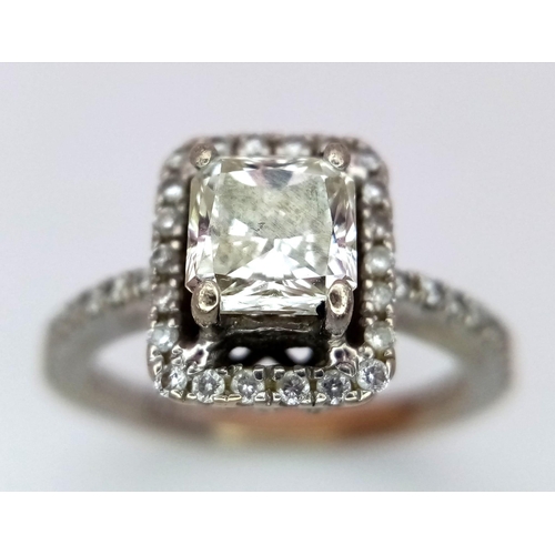 186 - A 14K White Gold Princess Cut Diamond Ring. A beautiful (slightly tinted) 1.13ct central princess cu... 