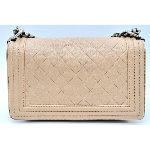 206 - A Chanel Beige Boy Bag. Leather exterior with silver-toned hardware, chain and leather adjustable st... 