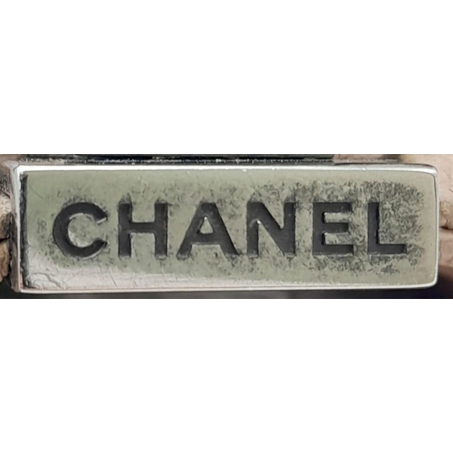 206 - A Chanel Beige Boy Bag. Leather exterior with silver-toned hardware, chain and leather adjustable st... 