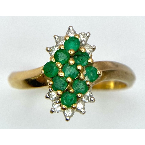 214 - A 18K YELLOW GOLD DIAMOND & EMERALD CLUSTER RING. TOTAL WEIGHT 3.2G. SIZE M