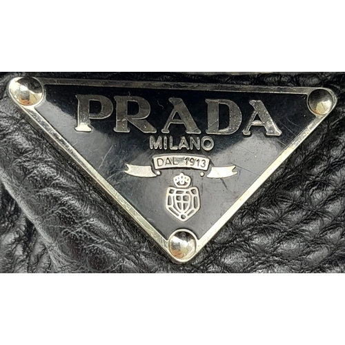 241 - A Prada Black Vitello Shoulder Bag. Leather exterior with silver-toned hardware, two straps, push lo... 