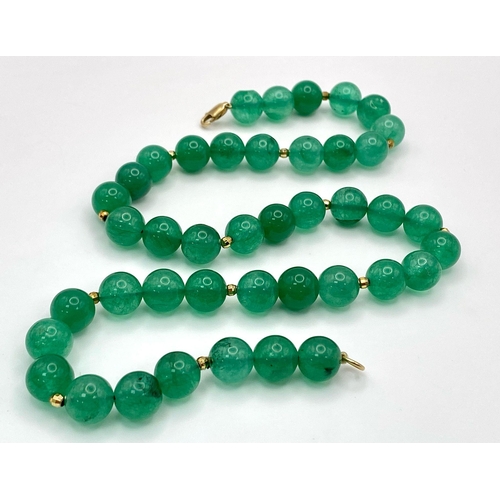 291 - A Jade Bead Necklace with 9K Gold Clasp. 42cm length.