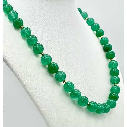 291 - A Jade Bead Necklace with 9K Gold Clasp. 42cm length.