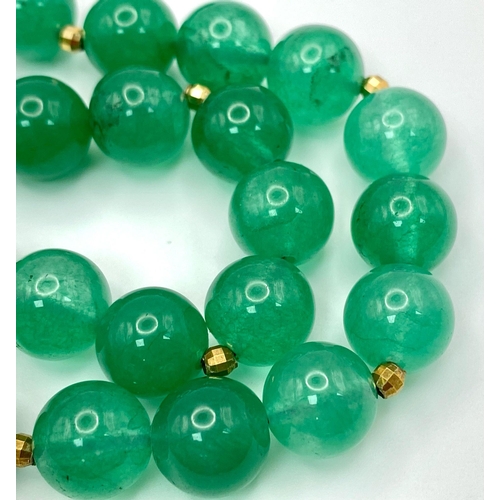 291 - A Jade Bead Necklace with 9K Gold Clasp. 42cm length.