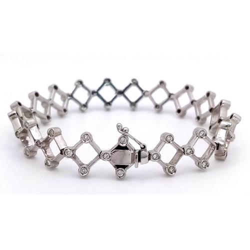 30 - An 18K White Gold and Diamond Tennis Bracelet. A wonderful geometric pattern containing 60 diamonds.... 