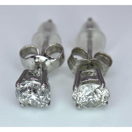 318 - A Pair of 18K Diamond Stud Earrings. Two brilliant round cut diamonds. 0.75ctw. 1.07g total weight. ... 