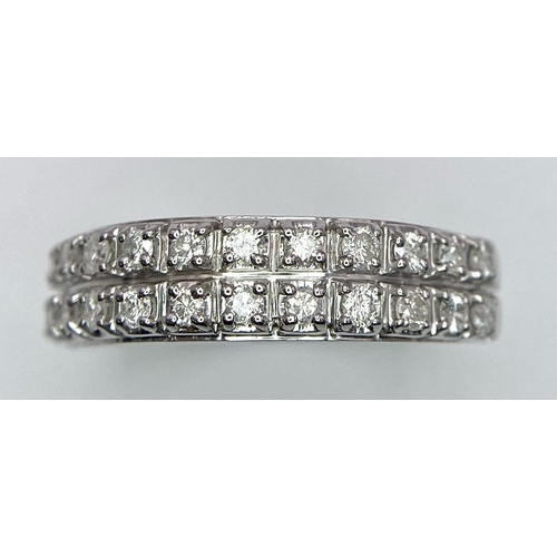 380 - A 9K WHITE GOLD 2 ROW 0.25CT DIAMOND BAND RING. TOTAL WEIGHT 3.4G. SIZE O