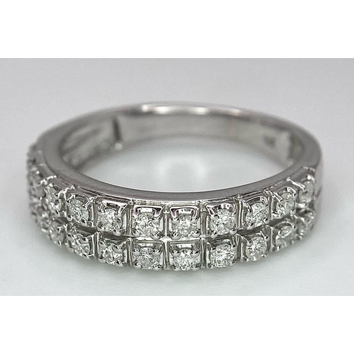 380 - A 9K WHITE GOLD 2 ROW 0.25CT DIAMOND BAND RING. TOTAL WEIGHT 3.4G. SIZE O