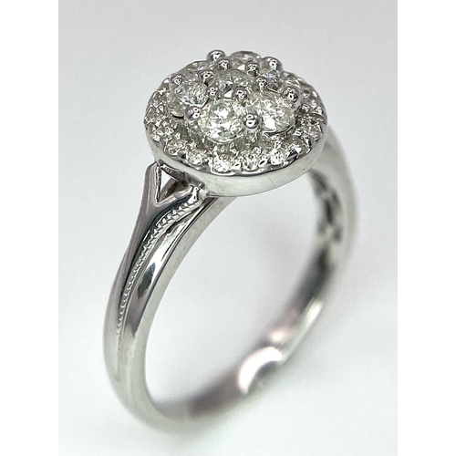 387 - A 9K WHITE GOLD 0.50CT DIAMOND CLUSTER RING. TOTAL WEIGHT 2.8G. SIZE I