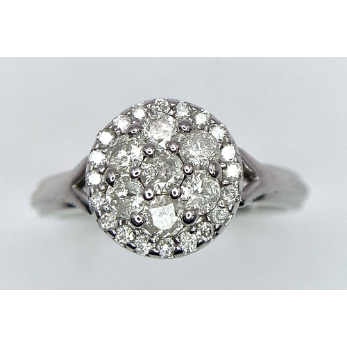 387 - A 9K WHITE GOLD 0.50CT DIAMOND CLUSTER RING. TOTAL WEIGHT 2.8G. SIZE I