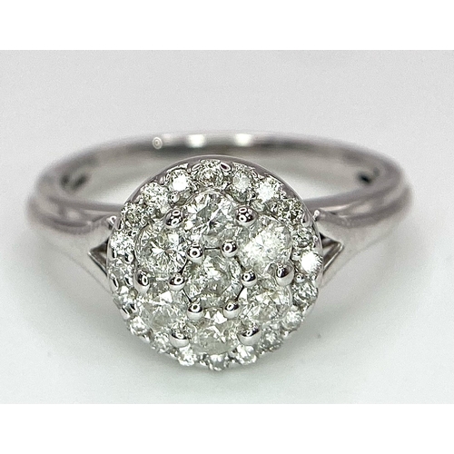 387 - A 9K WHITE GOLD 0.50CT DIAMOND CLUSTER RING. TOTAL WEIGHT 2.8G. SIZE I