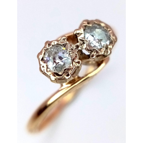 422 - An 18K Yellow Gold and Twin Diamond Crossover Ring. Brilliant round cut diamonds - 0.54ctw. Size M. ... 