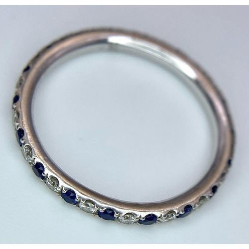 429 - A 14ct white gold diamond and sapphire full eternity ring set with 18 diamonds and 18 sapphires, 1.2... 