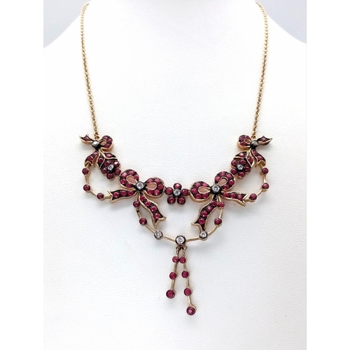 46 - An Art Deco Style 9K Yellow Gold Ruby and Diamond Lavaliere Necklace. Floral and bow decoration. 40c... 