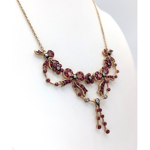 46 - An Art Deco Style 9K Yellow Gold Ruby and Diamond Lavaliere Necklace. Floral and bow decoration. 40c... 