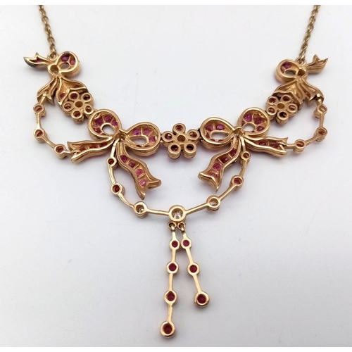 46 - An Art Deco Style 9K Yellow Gold Ruby and Diamond Lavaliere Necklace. Floral and bow decoration. 40c... 