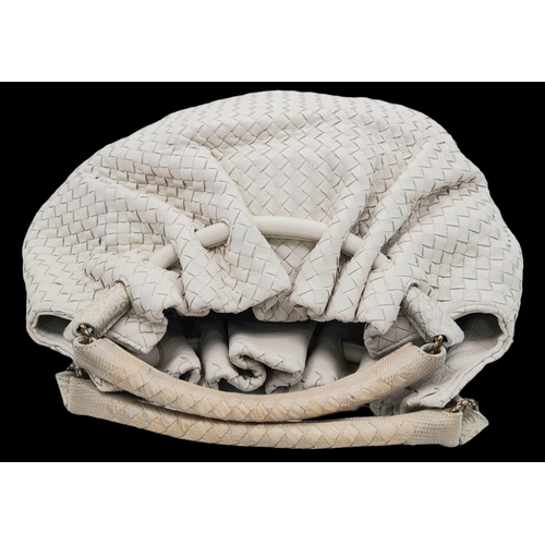 67 - A Bottega Veneta Cream Hobo Bag. Intracciato (woven) leather exterior with reptilian handles and bro... 