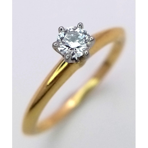 99 - A Tiffany and Co. 18K Yellow Gold Diamond Solitaire Ring. This VVS2 0.19ct brilliant round cut diamo... 