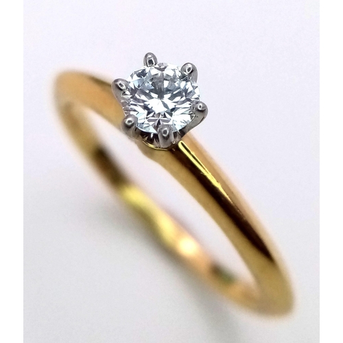 99 - A Tiffany and Co. 18K Yellow Gold Diamond Solitaire Ring. This VVS2 0.19ct brilliant round cut diamo... 