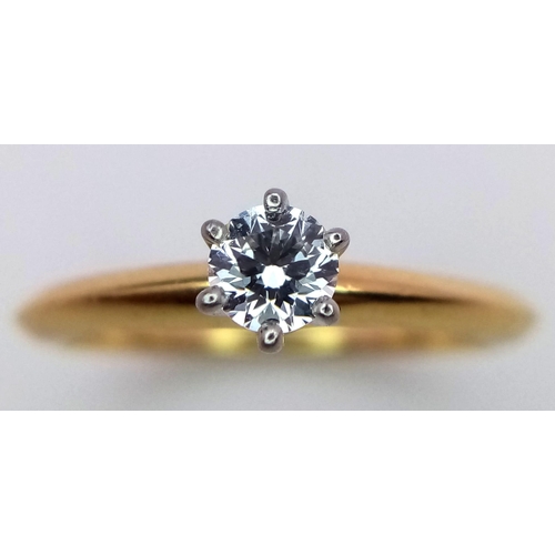 99 - A Tiffany and Co. 18K Yellow Gold Diamond Solitaire Ring. This VVS2 0.19ct brilliant round cut diamo... 