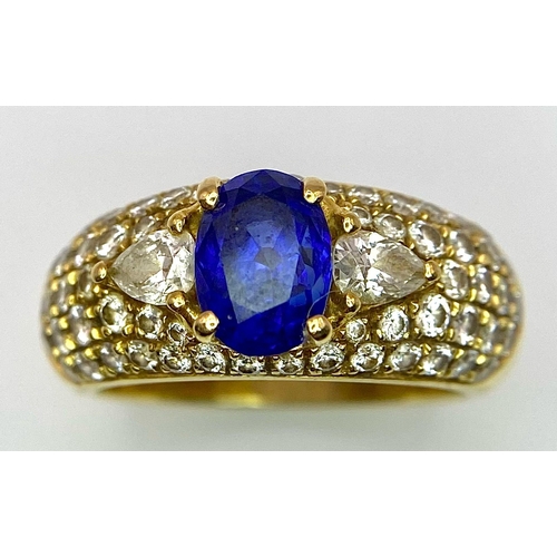 123 - Two Spectacular 18K Gold Rings. A sapphire and diamond ring - central oval sapphire with pave diamon... 