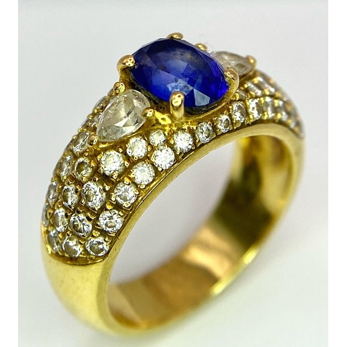 123 - Two Spectacular 18K Gold Rings. A sapphire and diamond ring - central oval sapphire with pave diamon... 