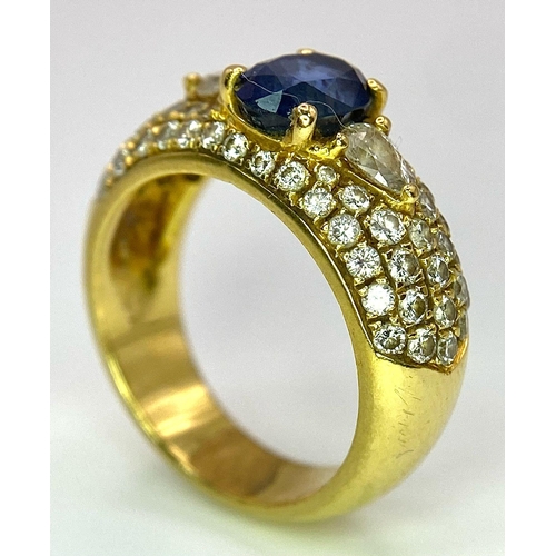 123 - Two Spectacular 18K Gold Rings. A sapphire and diamond ring - central oval sapphire with pave diamon... 