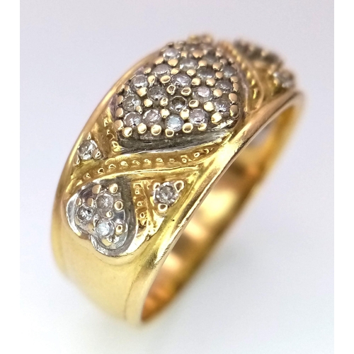 382 - A Vintage 18K Yellow Gold Diamond Decorative Heart Ring. A central pave diamond heart with scrolls a... 