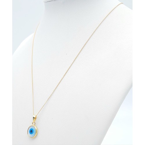 309 - An Evil Eye 18k Gold Pendant on an 18K Gold Disappearing Necklace. 20mm and 44cm. 1.85g total weight... 