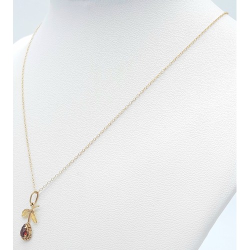 985 - A fancy 9K yellow gold Garnet flower pendant on delicate gold chain. Total weight 1.1G. Total length... 