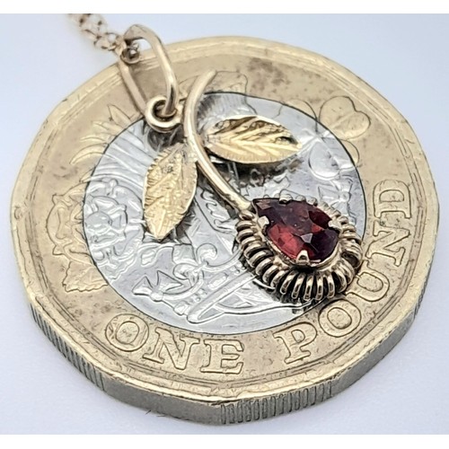 985 - A fancy 9K yellow gold Garnet flower pendant on delicate gold chain. Total weight 1.1G. Total length... 