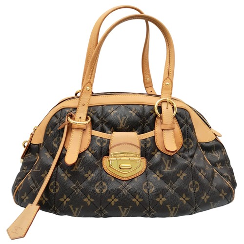 31 - A Louis Vuitton Monogram Etoile Bowling Bag. Quilted leather exterior with gold-toned hardware, padl... 