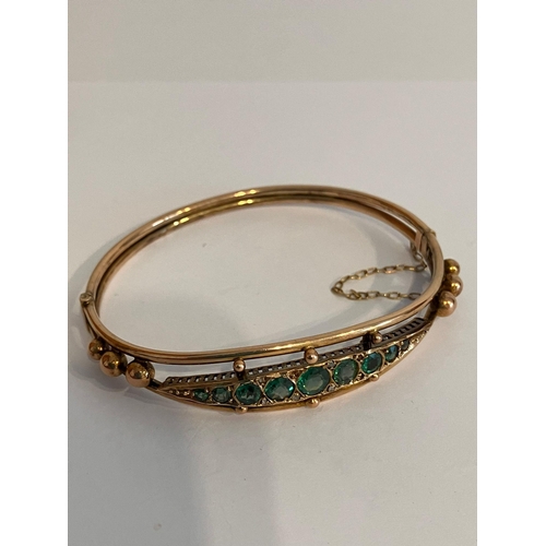 119 - Vintage 9 carat GOLD BANGLE Set to top with green gemstones. Having clear hallmark for Smith and Pep... 