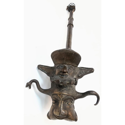 225 - An Antique Bronze Two-Piece Pipe. Gothic, almost Satanic Decorative Base. 66cm length.