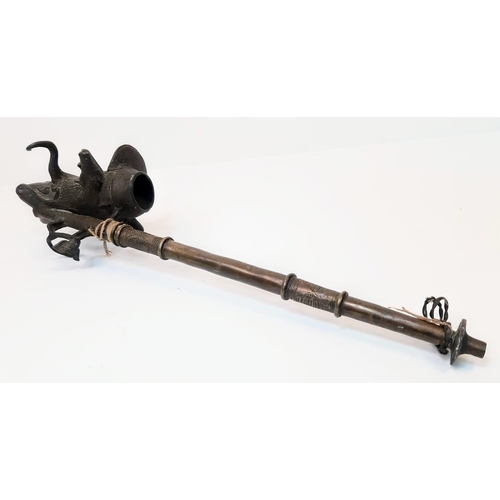 225 - An Antique Bronze Two-Piece Pipe. Gothic, almost Satanic Decorative Base. 66cm length.