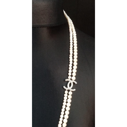 410 - A Long Double Row Cultured Pearl Necklace with a Silver CC Clasp. 80cm length.