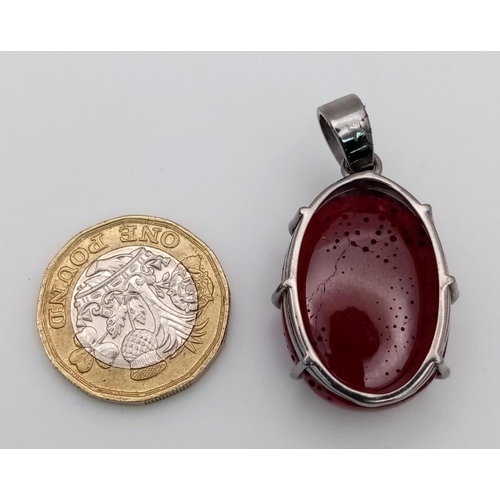 1614 - A Ruby Silver Pendant. Oval cut set in 925 Sterling silver. 57ctw. W-15.5g. 4cm. Ref: VO-1953. Comes... 