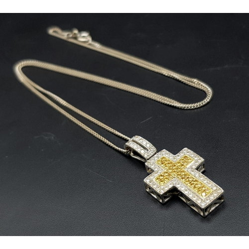 114 - An 18K White and Yellow Gold Diamond Encrusted Cross Pendant on an 18K White Gold Disappearing Neckl... 