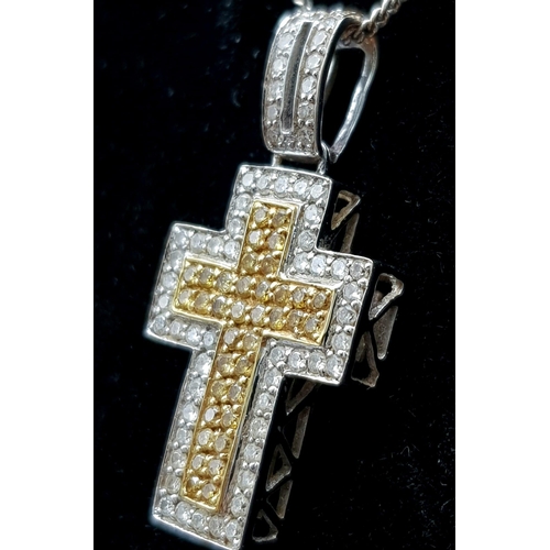 114 - An 18K White and Yellow Gold Diamond Encrusted Cross Pendant on an 18K White Gold Disappearing Neckl... 