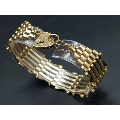 295 - A 9K GOLD 8 GATE BRACELET WITH HEART PADLOCK AND SAFETY CHAIN .   12.6gms