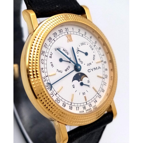 428 - A Cyma Quartz Moonphase Watch. Black leather strap. Gilded case - 32mm. White dial with three sub di... 