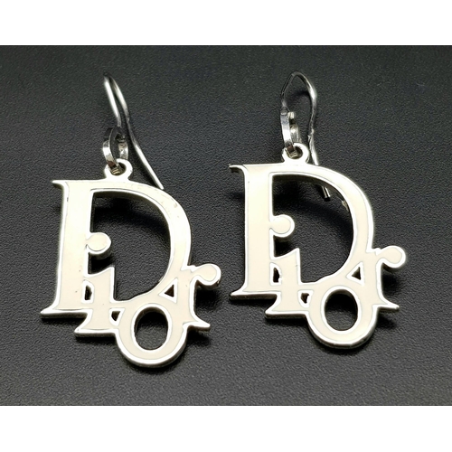 591 - A Pair of Christian Dior White Enamel Earrings. Logo drop -3cm. Ref: 104270